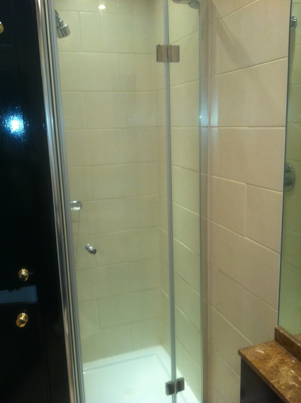Frameless glass shower enclosure with chrome fittings in Southgate